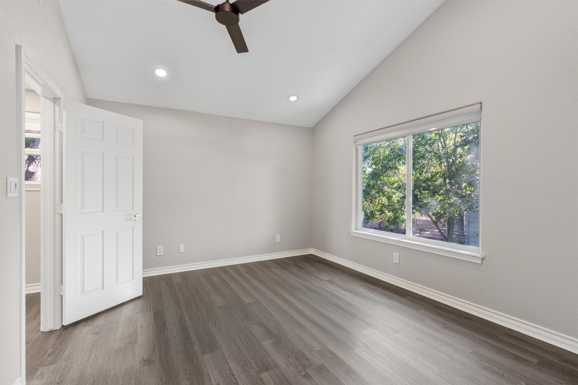 1209 Casey Street, Unit A Austin, TX 78745 - Photo 7 of 14 an empty room with wooden floor and windows