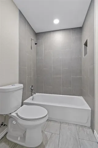 a bathroom with a toilet a sink and bathtub