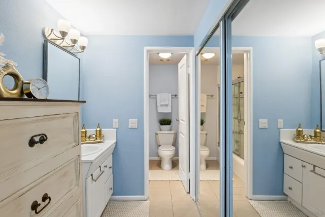 a bathroom with a mirror sink and vanity