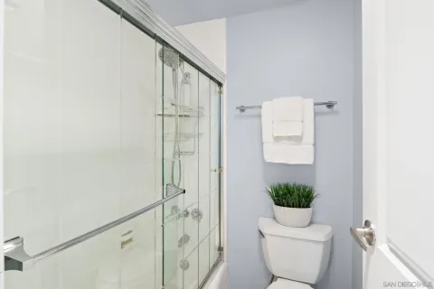 a bathroom with a toilet and a shower