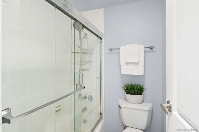 a bathroom with a toilet and a shower