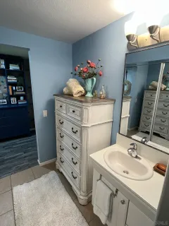 a bathroom with a sink vanity and a mirror