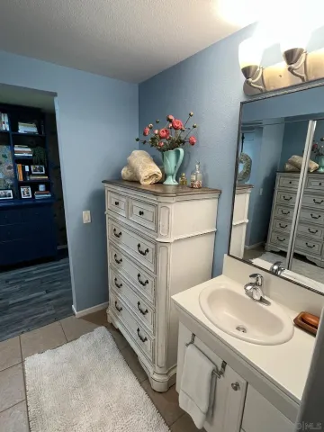 a bathroom with a sink vanity and a mirror