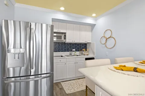 a kitchen with stainless steel appliances granite countertop a refrigerator sink and cabinets