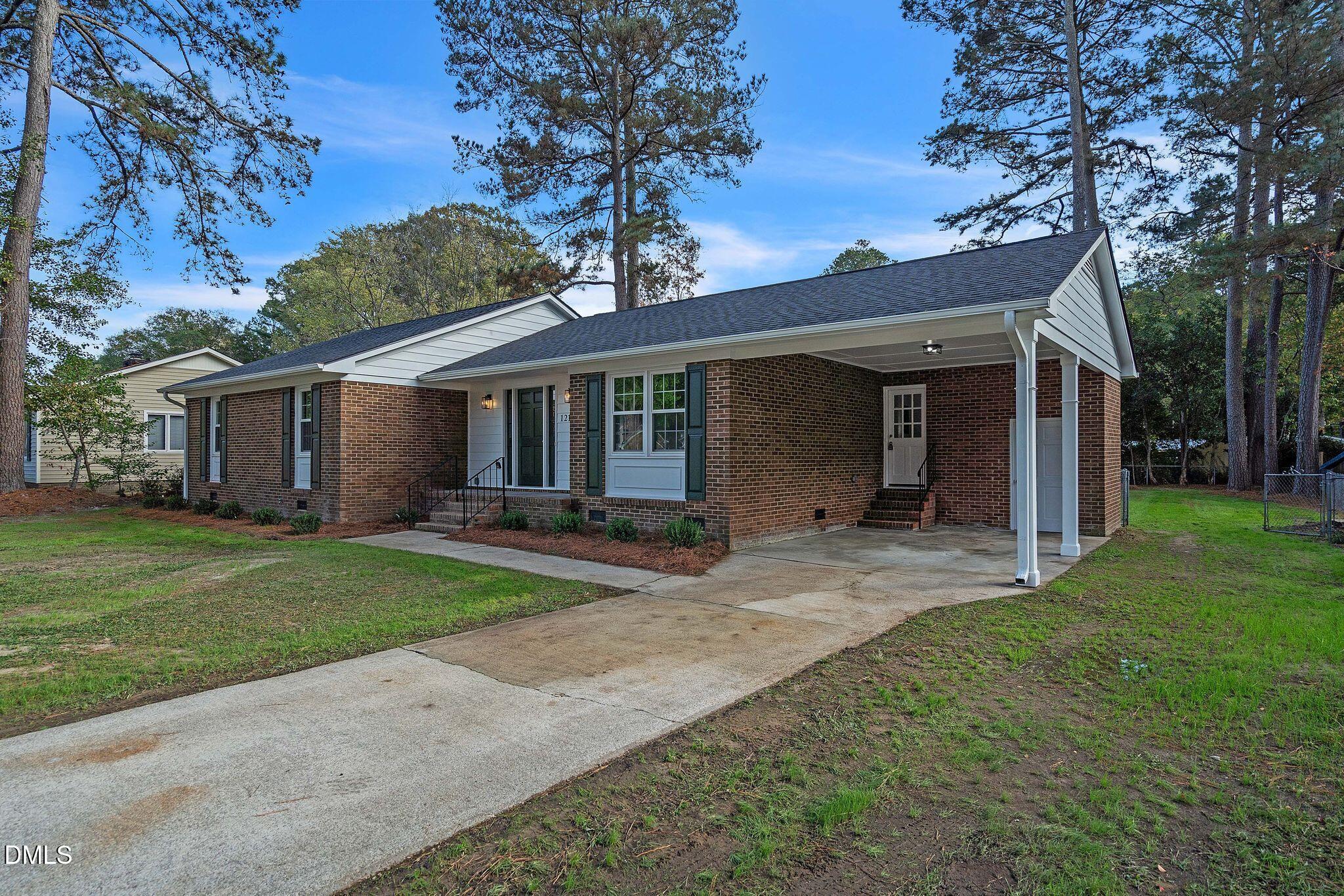 1219 Queen Anne Road Northwest Wilson, NC 27896 - Photo 21 of 26 front view of a house with a yard