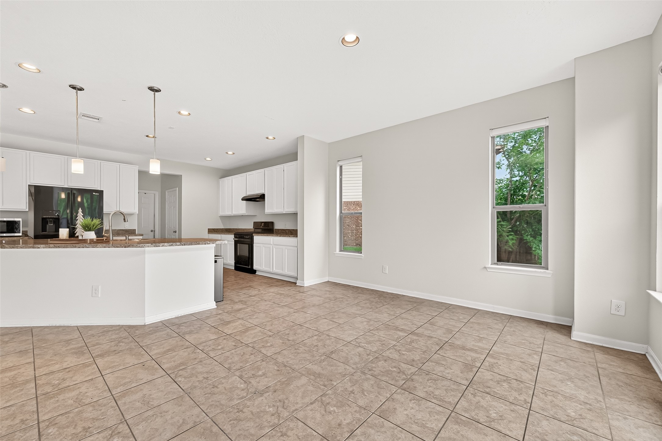 21454 Piralta Ridge Lane Katy, TX 77449 - Photo 11 of 33 a big room with stainless steel appliances kitchen island granite countertop a refrigerator a stove a sink and a white cabinets