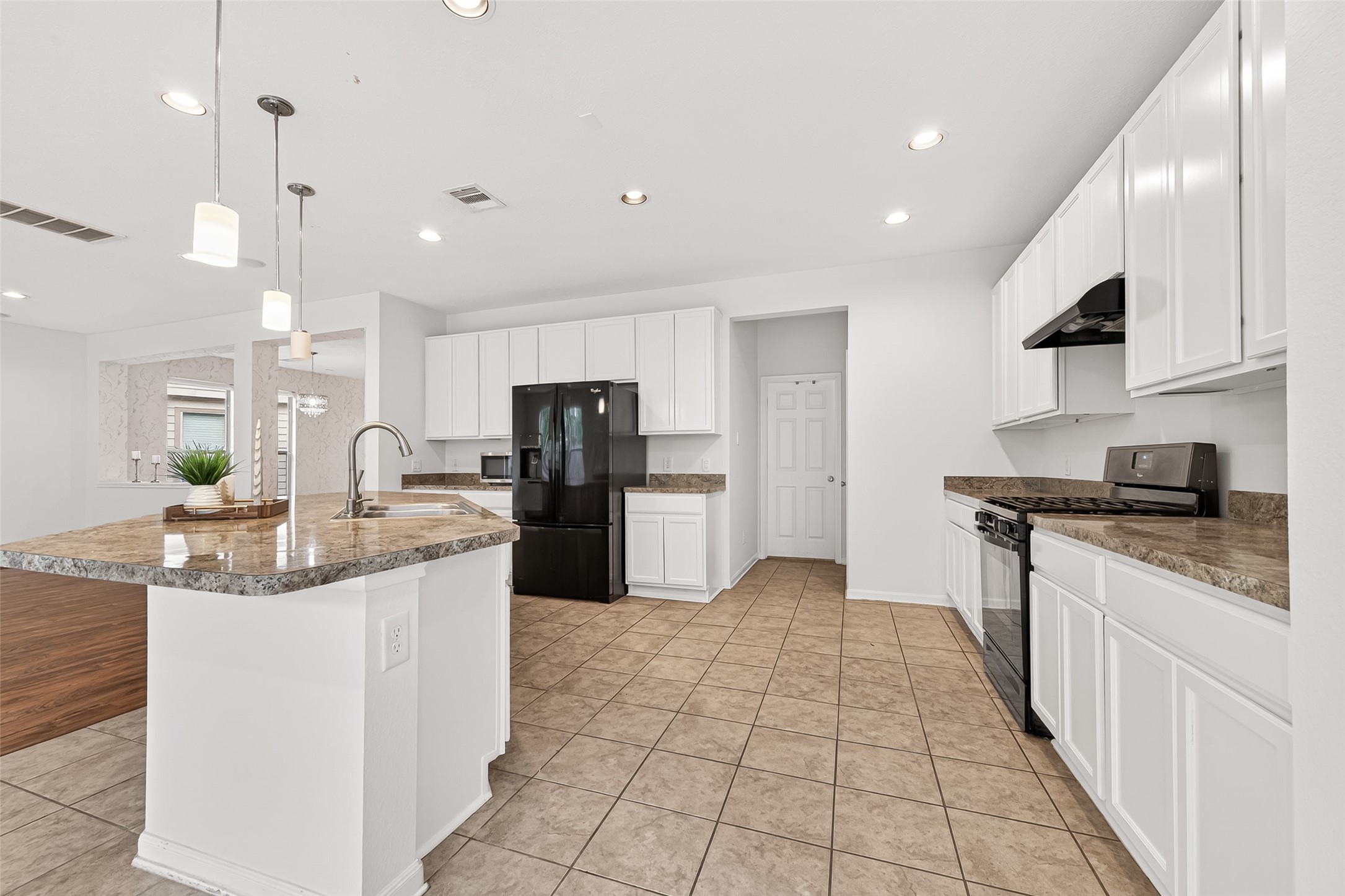 21454 Piralta Ridge Lane Katy, TX 77449 - Photo 12 of 33 a kitchen with stainless steel appliances granite countertop a sink and a refrigerator