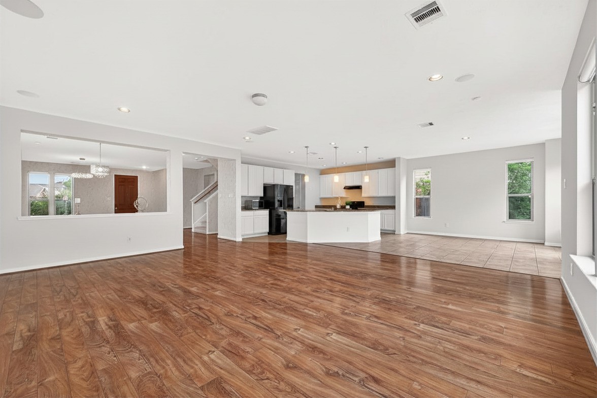 21454 Piralta Ridge Lane Katy, TX 77449 - Photo 7 of 33 a view of an empty room with wooden floor and a window