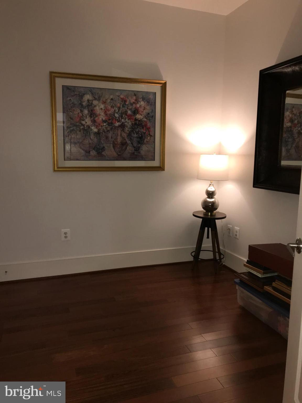 4301 Military Road Northwest, Unit 208 Washington, DC 20015 - Photo 14 of 32 a view of a workspace with furniture and a flat screen tv