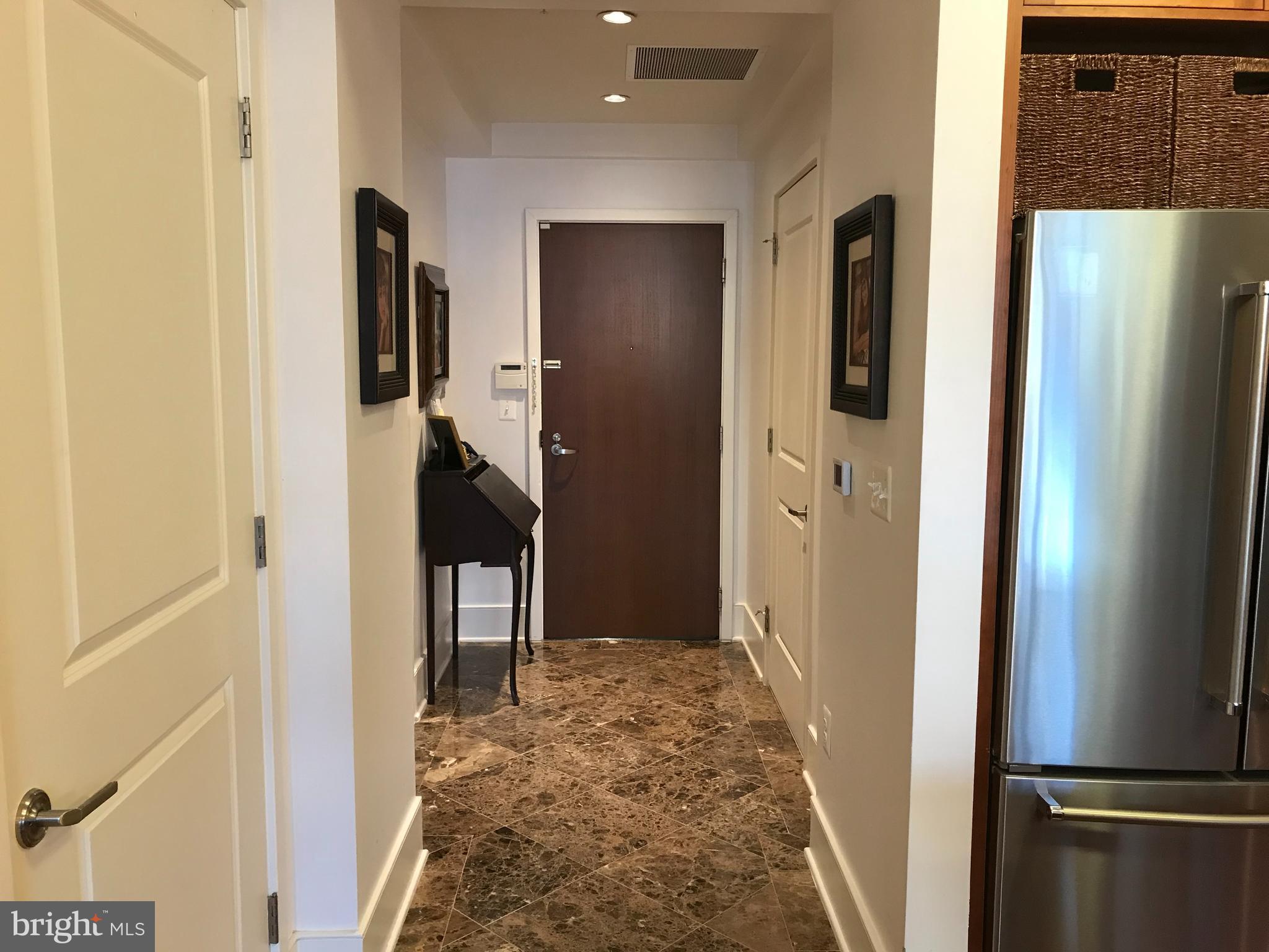 4301 Military Road Northwest, Unit 208 Washington, DC 20015 - Photo 2 of 32 a view of a hallway with windows and entryway