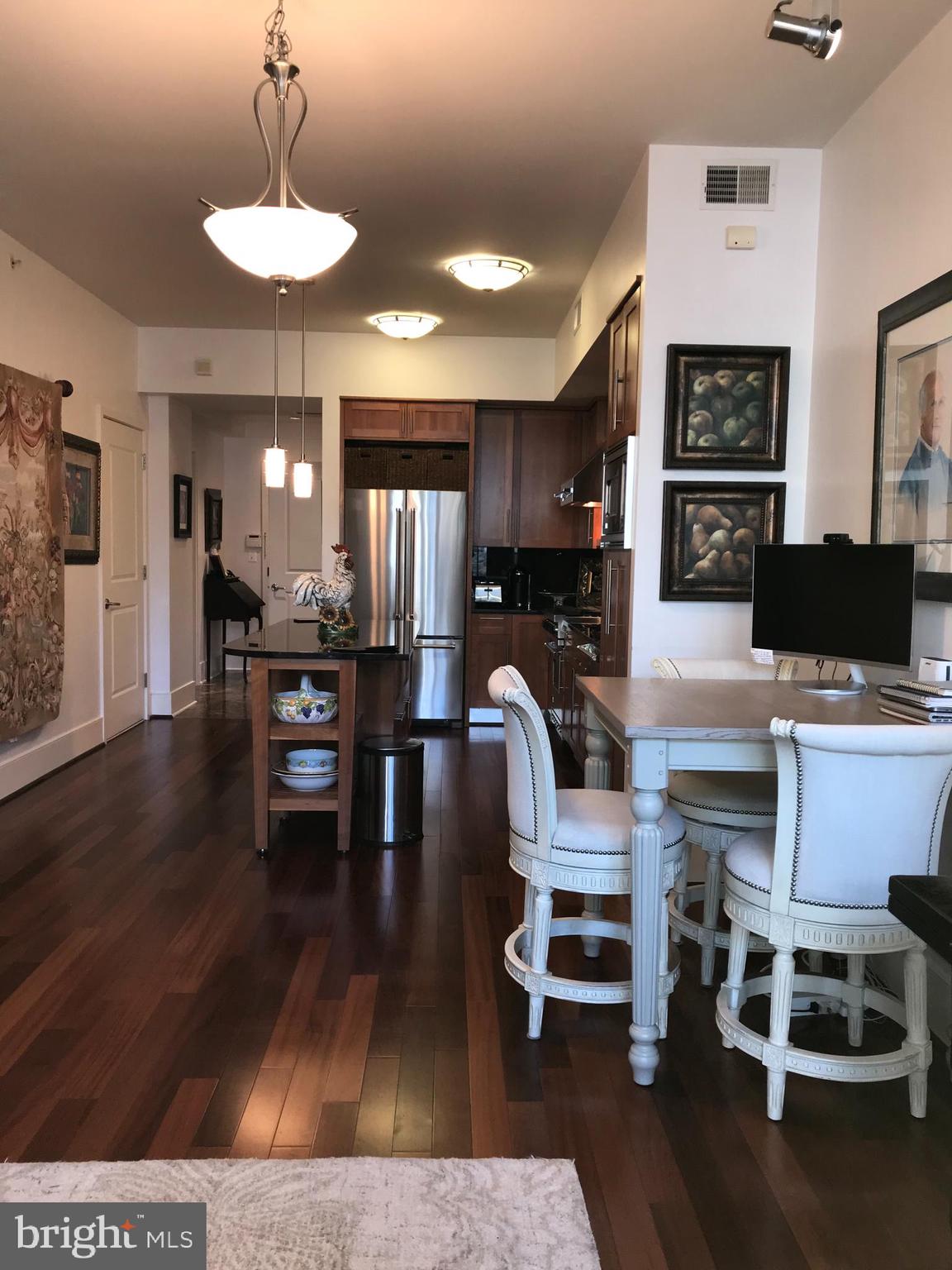 4301 Military Road Northwest, Unit 208 Washington, DC 20015 - Photo 6 of 32 a view of a dining room with furniture and wooden floor