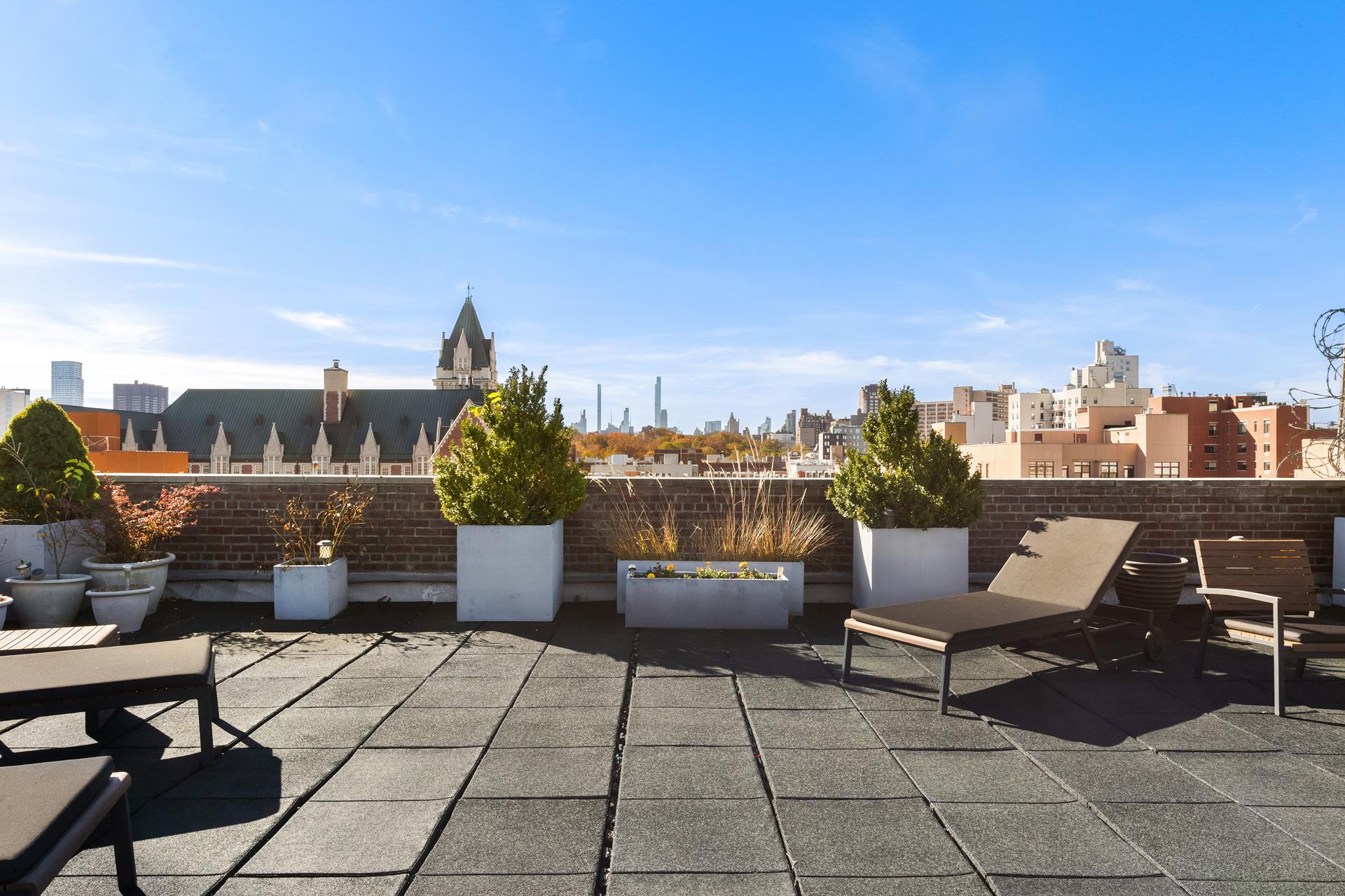 229 West 116th Street, Unit 2B Manhattan, NY 10026 - Photo 14 of 18 a roof deck with outdoor seating and city view