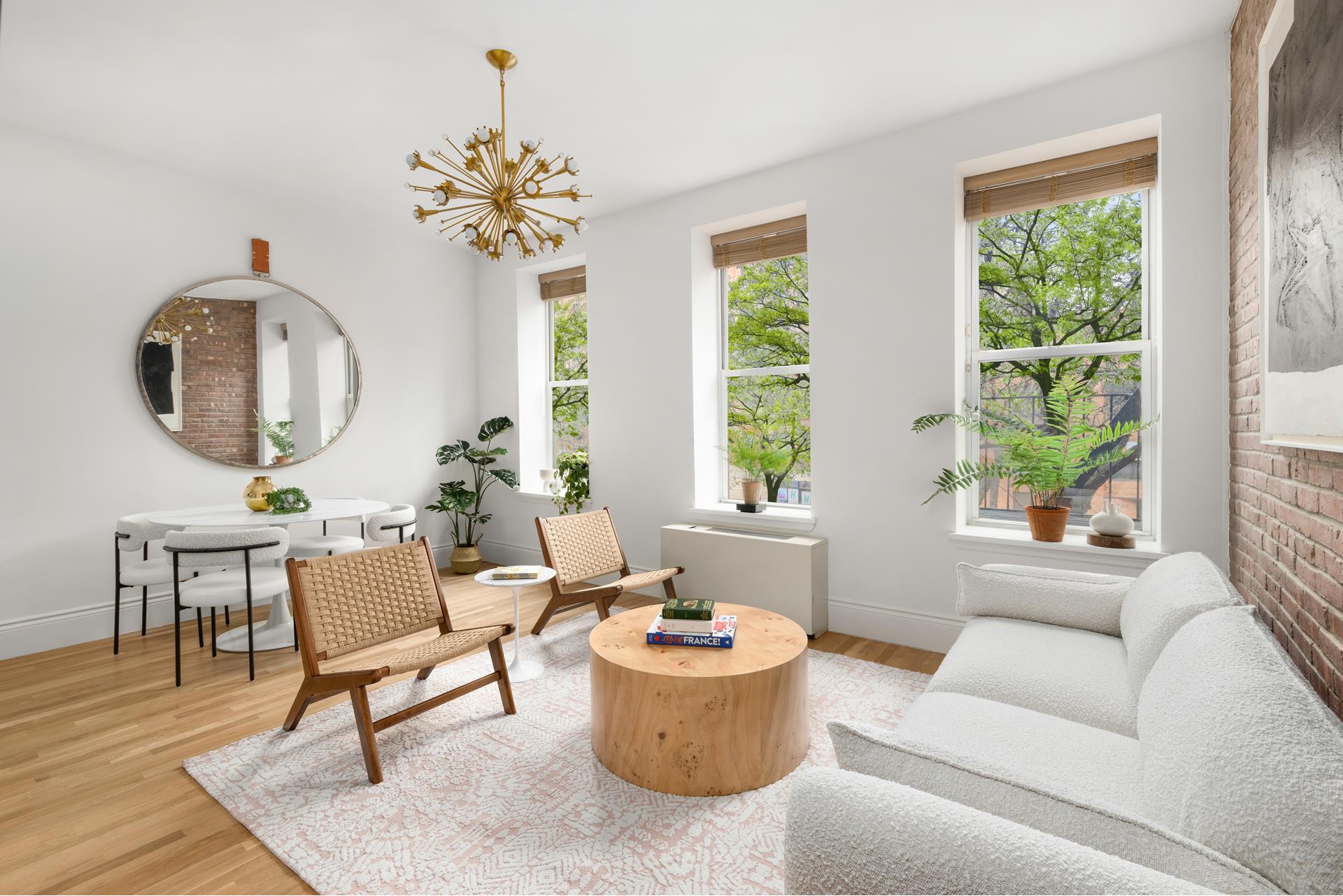 229 West 116th Street, Unit 2B Manhattan, NY 10026 - Photo 15 of 18 a living room with furniture and a large window