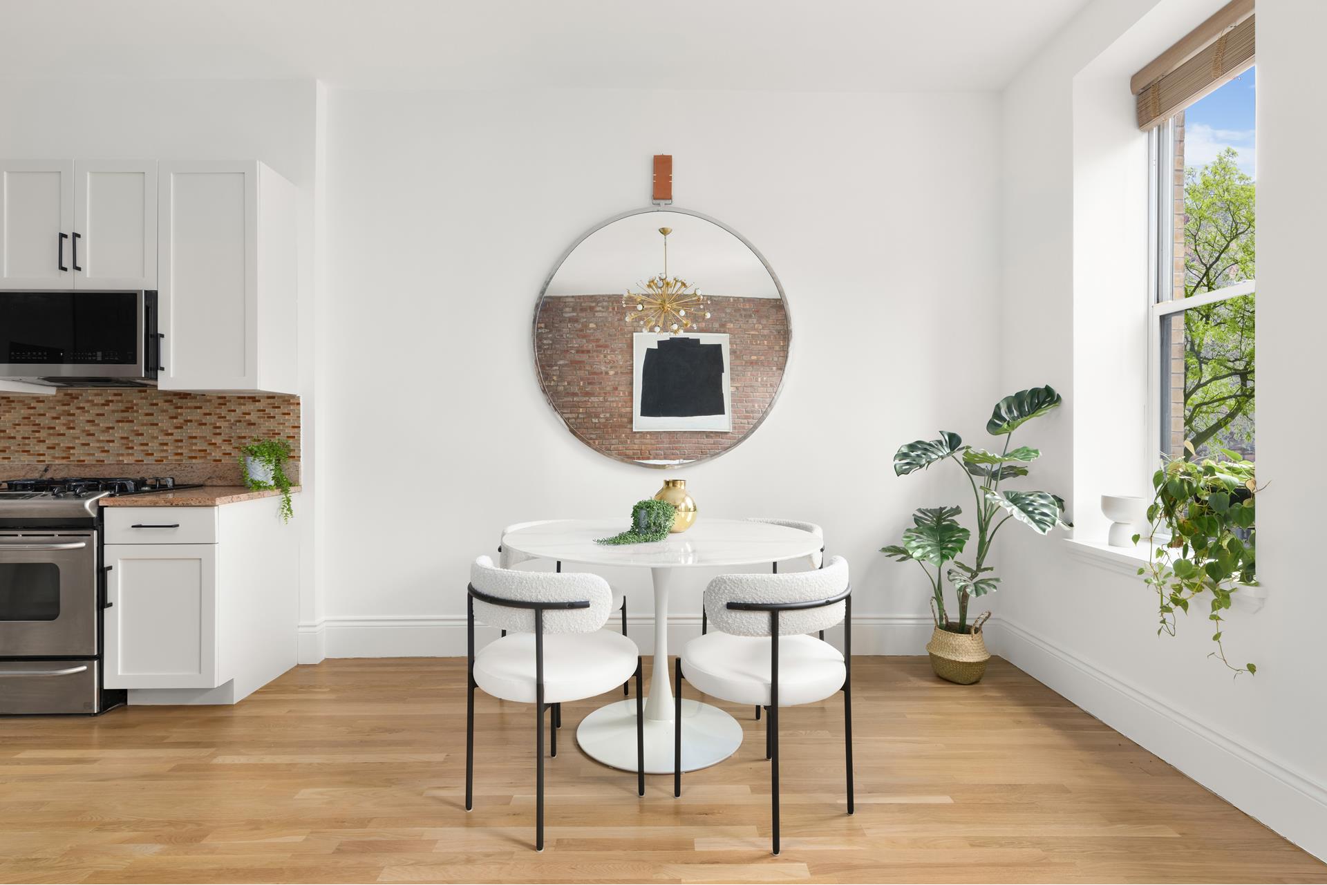 229 West 116th Street, Unit 2B Manhattan, NY 10026 - Photo 3 of 18 a kitchen with a table and chairs in it