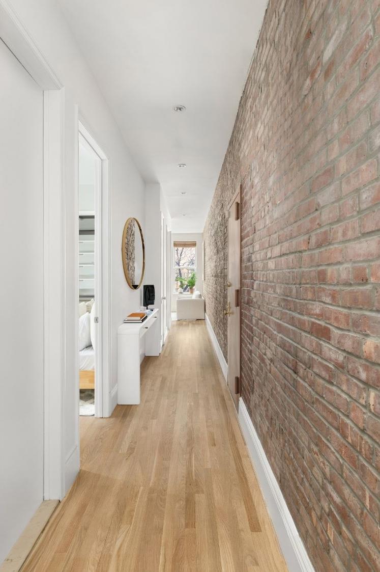 229 West 116th Street, Unit 2B Manhattan, NY 10026 - Photo 6 of 18 a view of a hallway with wooden floor and furniture