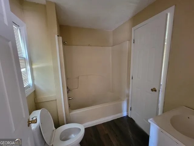 a bathroom with a toilet and a bathtub