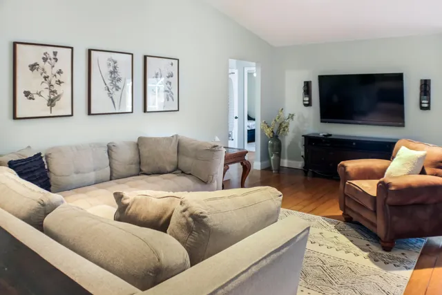 a living room with furniture a rug and a window