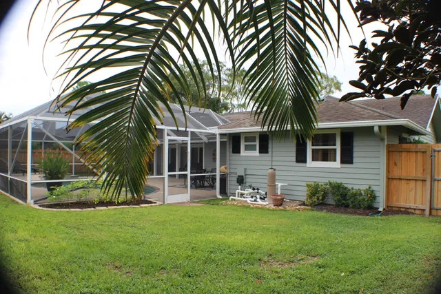 a view of a house with backyard and sitting area