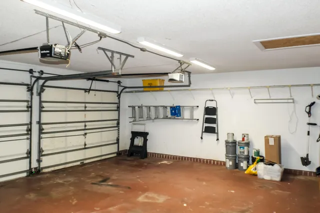 a front view of a house with a garden and trees