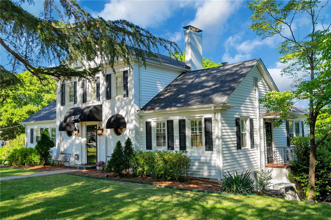 1107 Springdale Road Anderson, SC 29621 - Photo 2 of 49 This charming residence showcases classic architectural details and a welcoming exterior amidst lush greenery.