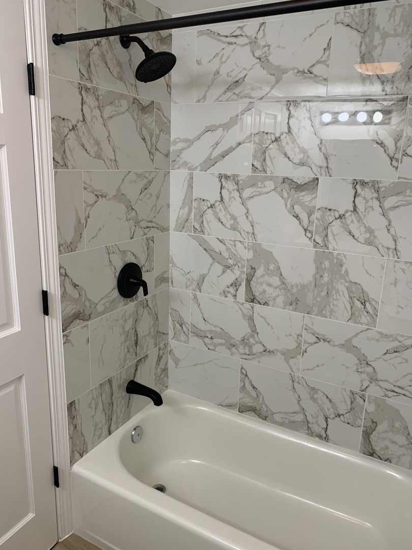 1303 West Flournoy Street, Unit 1F Chicago, IL 60607 - Photo 14 of 15 a bathroom with a bathtub