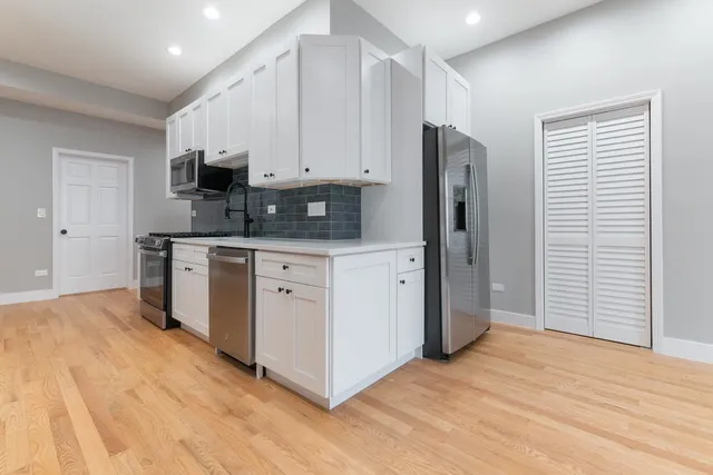a kitchen with stainless steel appliances a refrigerator sink and cabinets