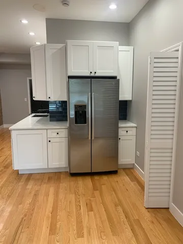 a kitchen with stainless steel appliances a refrigerator sink and microwave