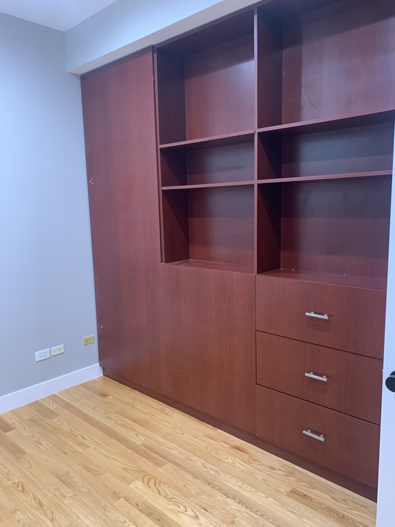 1303 West Flournoy Street, Unit 1F Chicago, IL 60607 - Photo 9 of 15 a view of room with empty racks