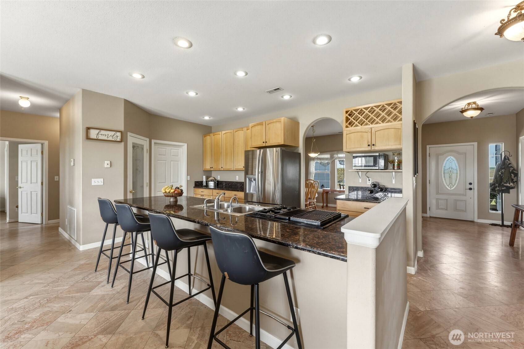 219 Reeds Road Touchet, WA 99360 - Photo 11 of 40 a kitchen with stainless steel appliances kitchen island granite countertop a sink and cabinets