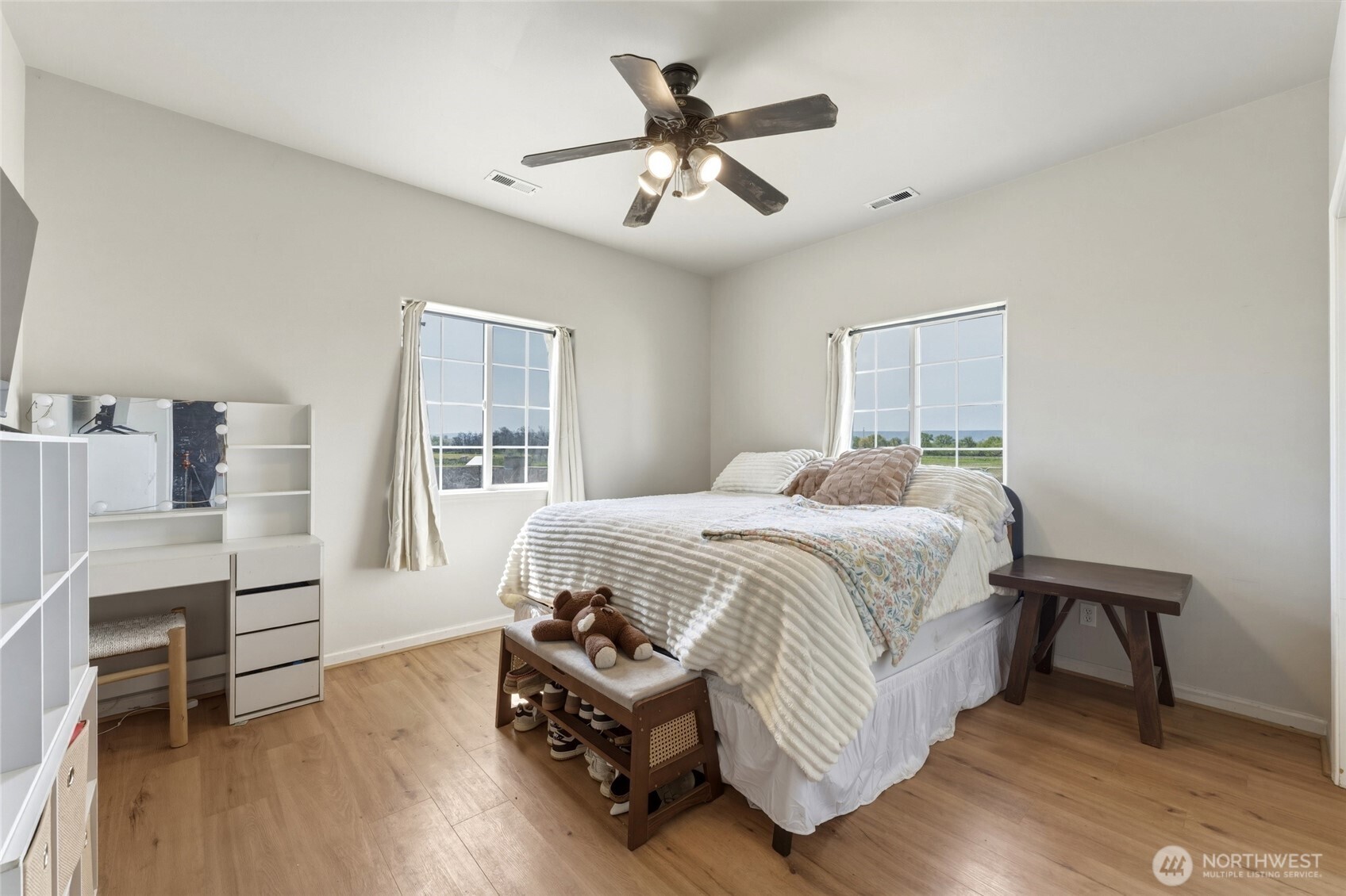 219 Reeds Road Touchet, WA 99360 - Photo 28 of 40 a bedroom with a bed and wooden floor