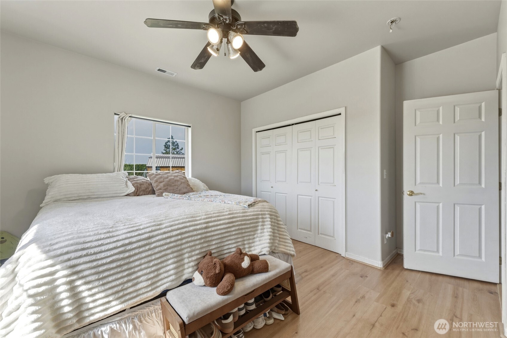 219 Reeds Road Touchet, WA 99360 - Photo 29 of 40 a bedroom with a bed and wooden floor