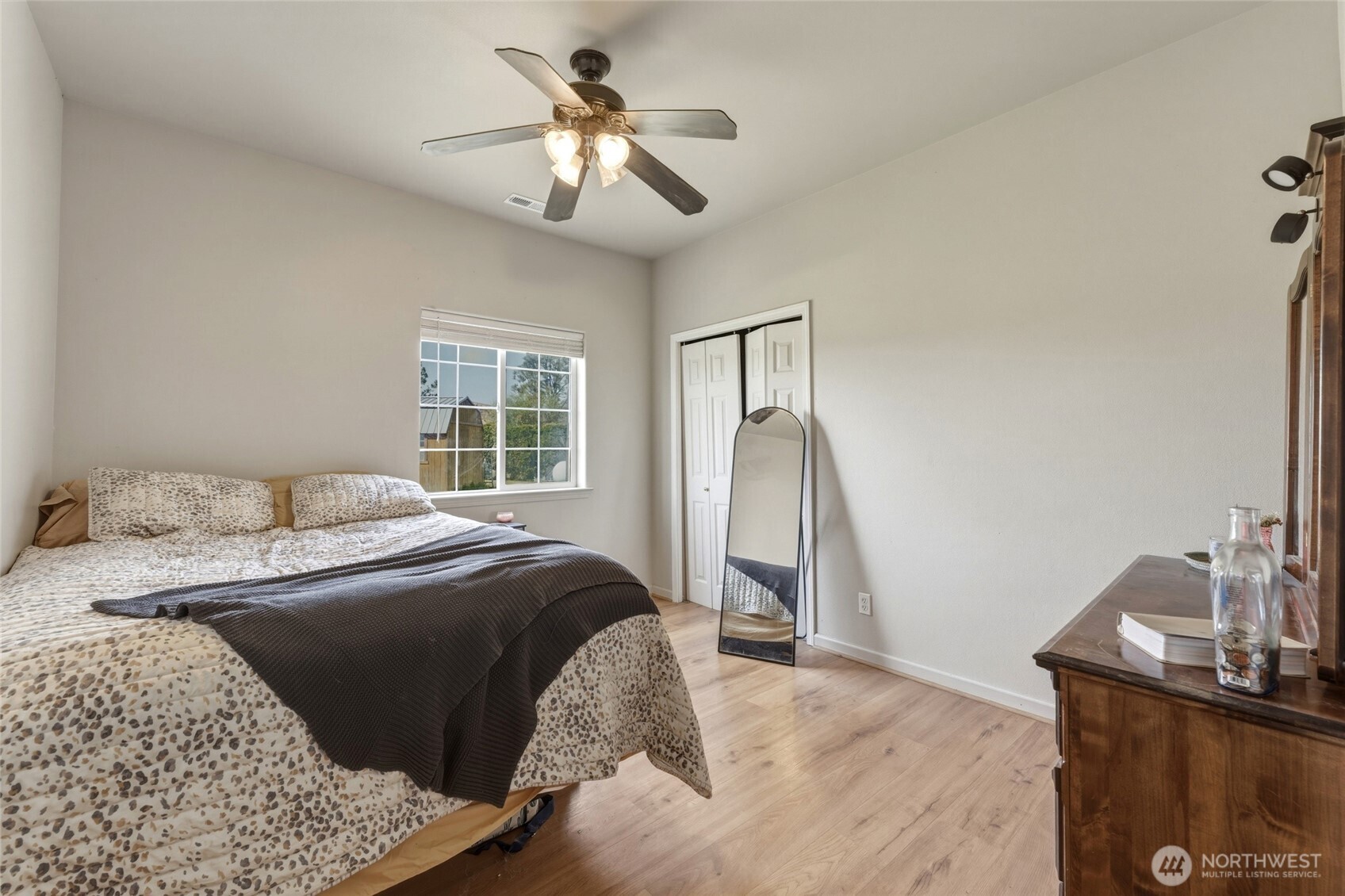 219 Reeds Road Touchet, WA 99360 - Photo 30 of 40 a bedroom with a bed and a chandelier