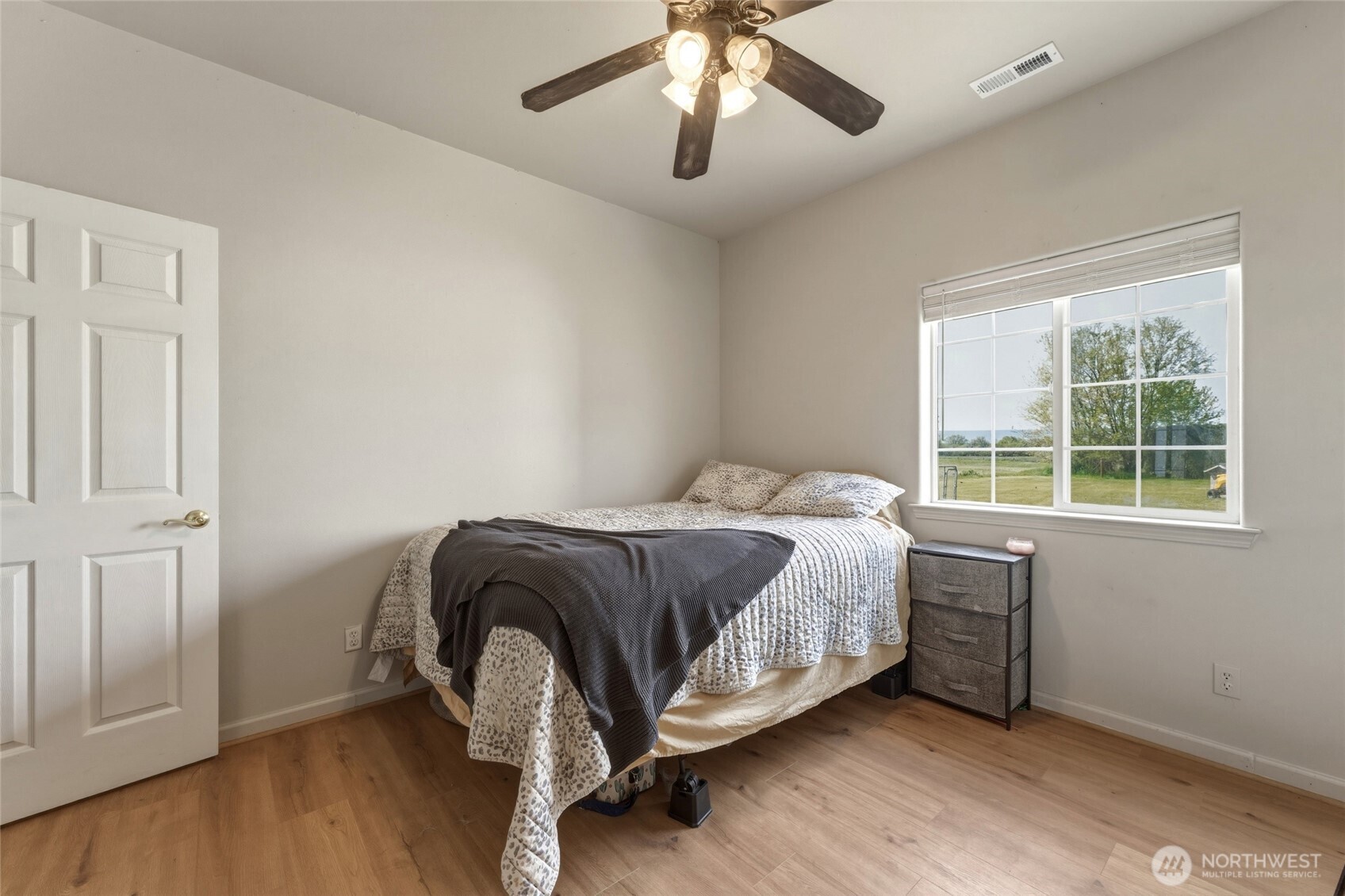 219 Reeds Road Touchet, WA 99360 - Photo 31 of 40 a bedroom with a bed and wooden floor