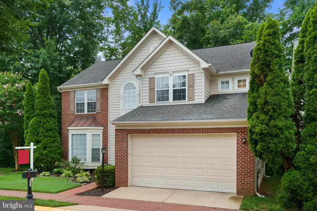 a front view of a house with a yard garage and outdoor seating