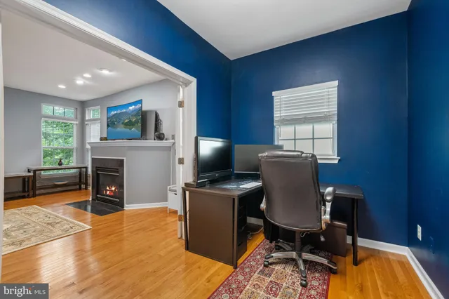 a view of a workspace with furniture and a fireplace