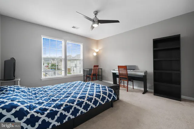a bedroom with furniture and a window