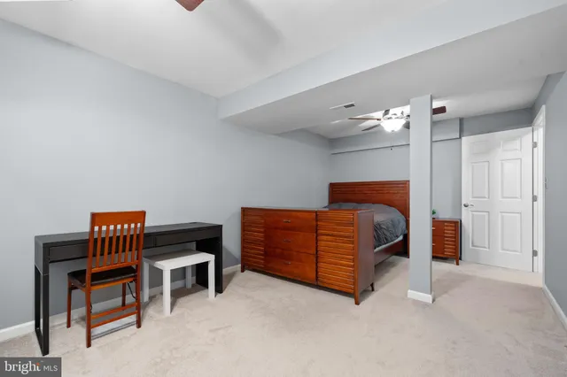 a bedroom with a bed and a ceiling fan