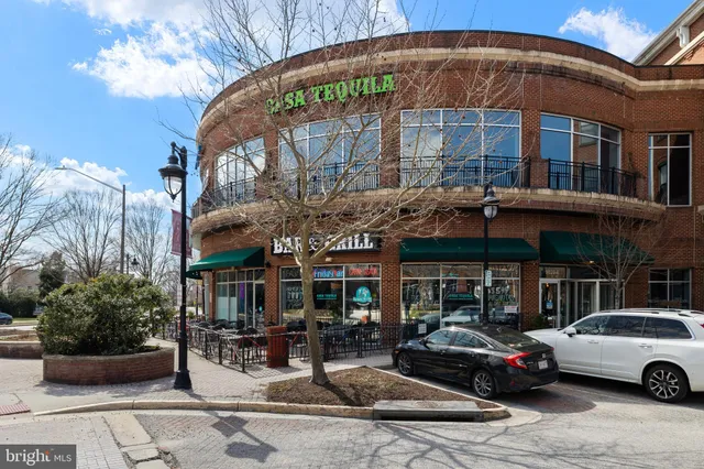 a view of a house with large trees in a yard