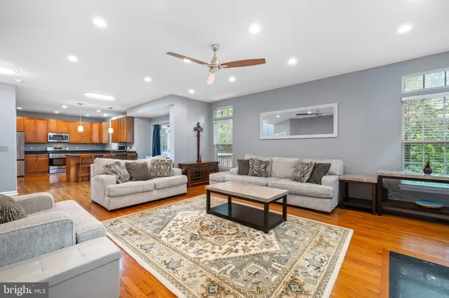 a living room with furniture and view of kitchen