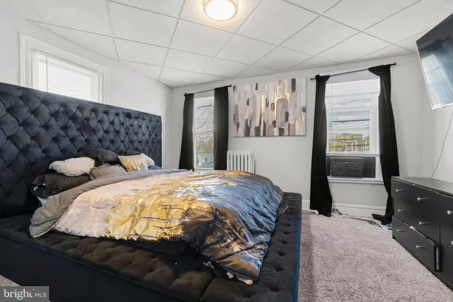 a bedroom with bed and window