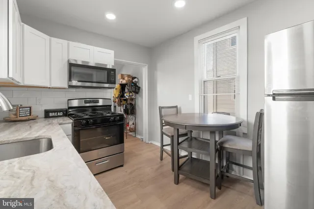 a kitchen with a sink appliances and cabinets