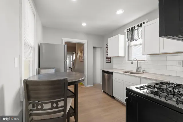 a kitchen with refrigerator and furniture