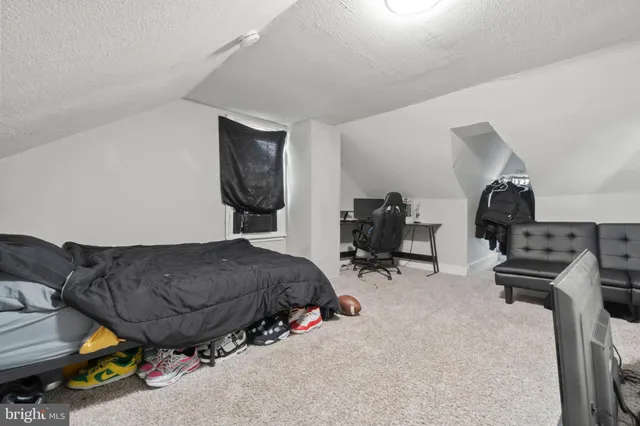 a bedroom with a bed and a washing machine