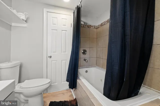 a bathroom with a toilet and a tub