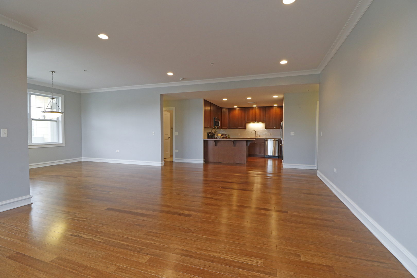 970 Harris Road, Unit 22 Grayslake, IL 60030 - Photo 6 of 42 an empty room with wooden floor and dining room