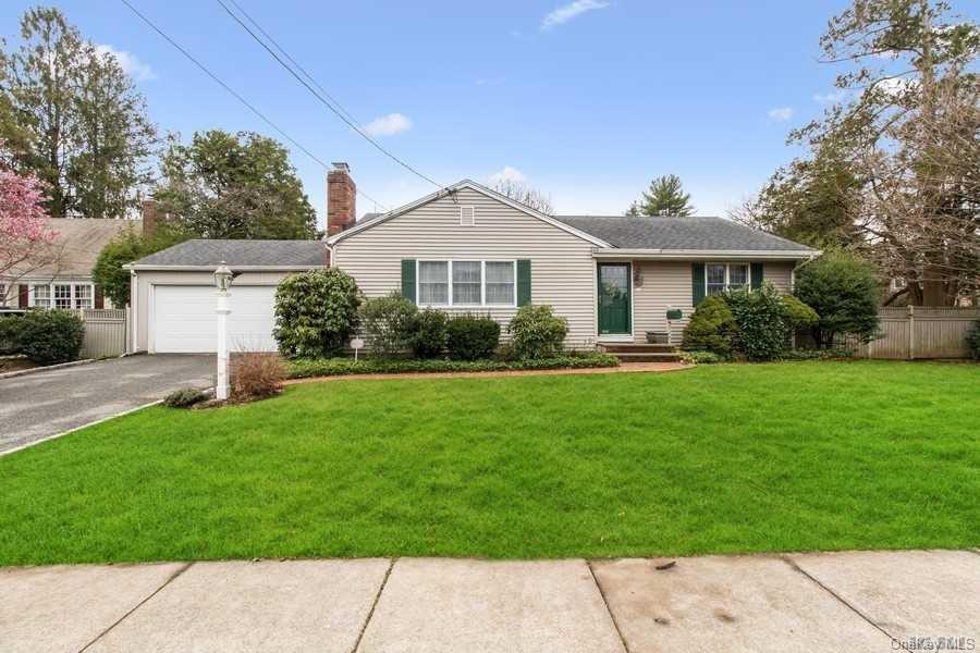 23 Meadowbrook Road Syosset, NY 11791 - Photo 1 of 1 a front view of a house with a garden