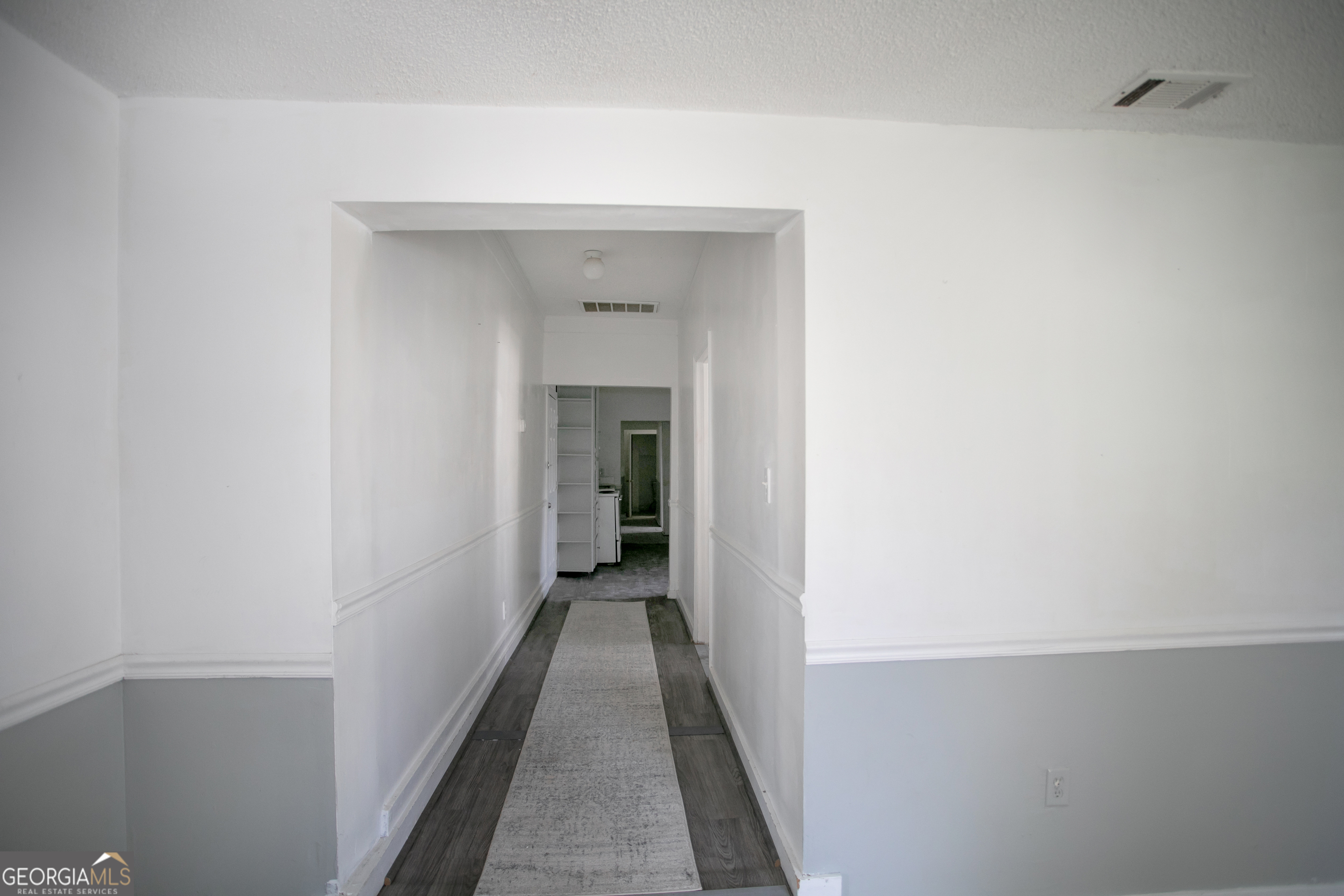 402 Boulevard Street Fort Valley, GA 31030 - Photo 5 of 10 a view of a hallway with wooden floor