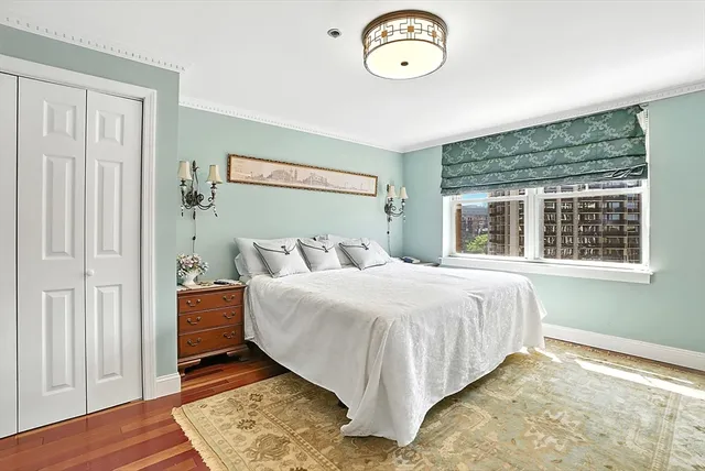 a bedroom with a large bed and a dresser