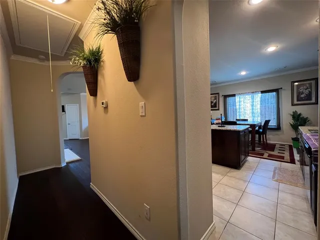 a walk in closet with wooden floor