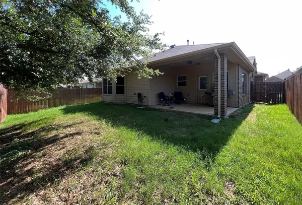 a view of a house with backyard and porch